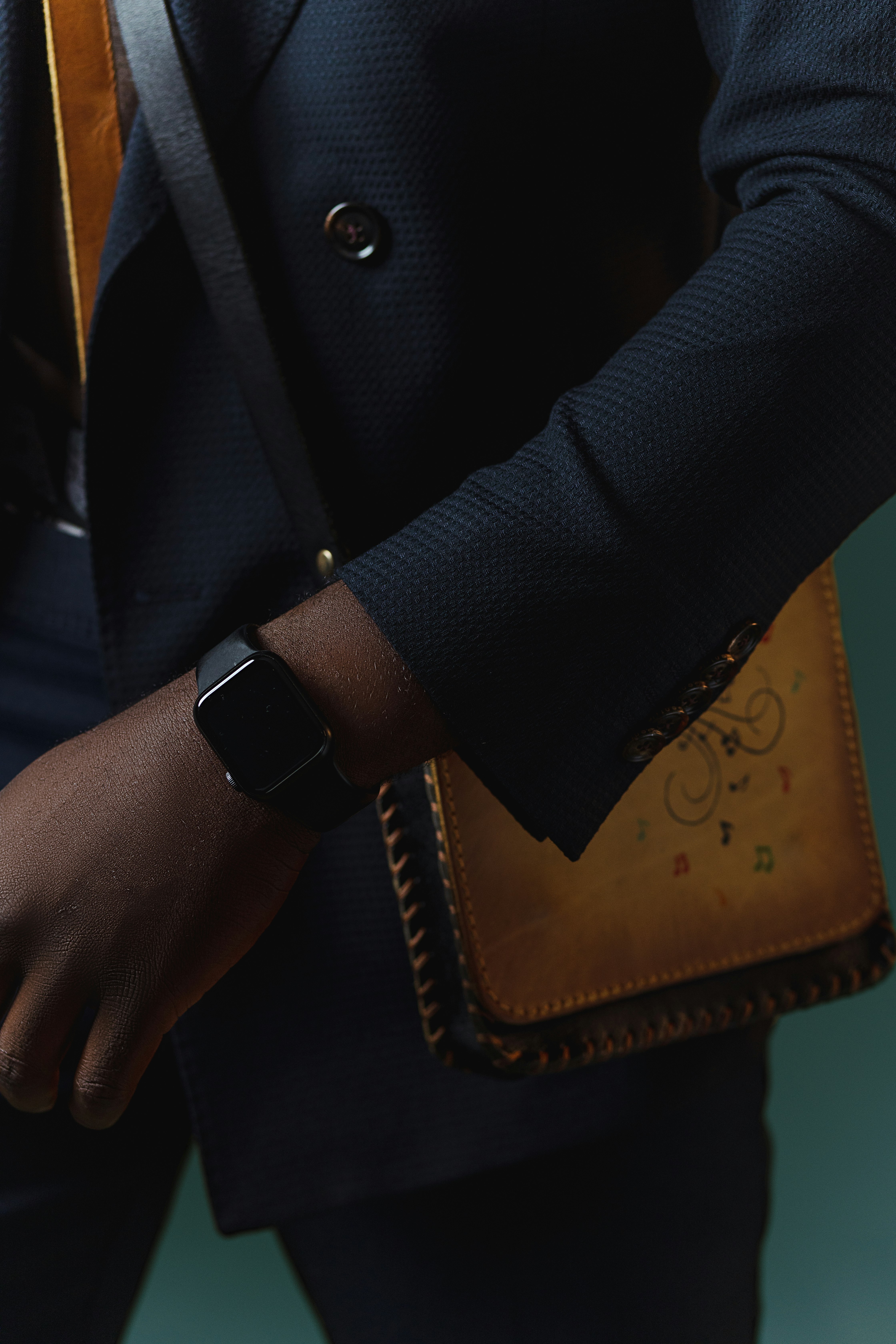 person wearing black leather strap watch